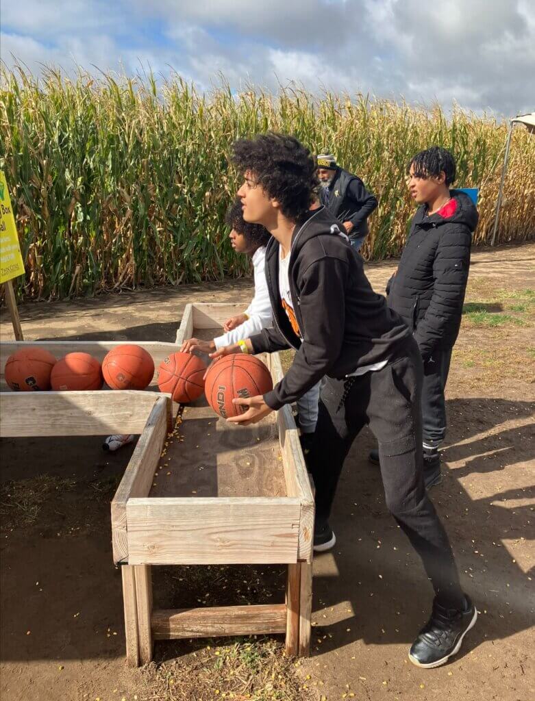 Youth playing basketball game at a Corn Maze