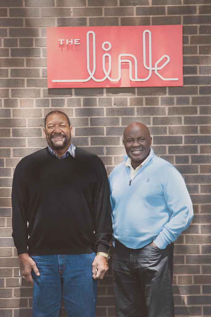 Jim and Oscar in front of Link sign